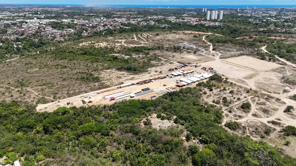 Vista aérea de área de terraplenagem com canteiro de obras em Santa Lúcia, com a cidade ao fundo